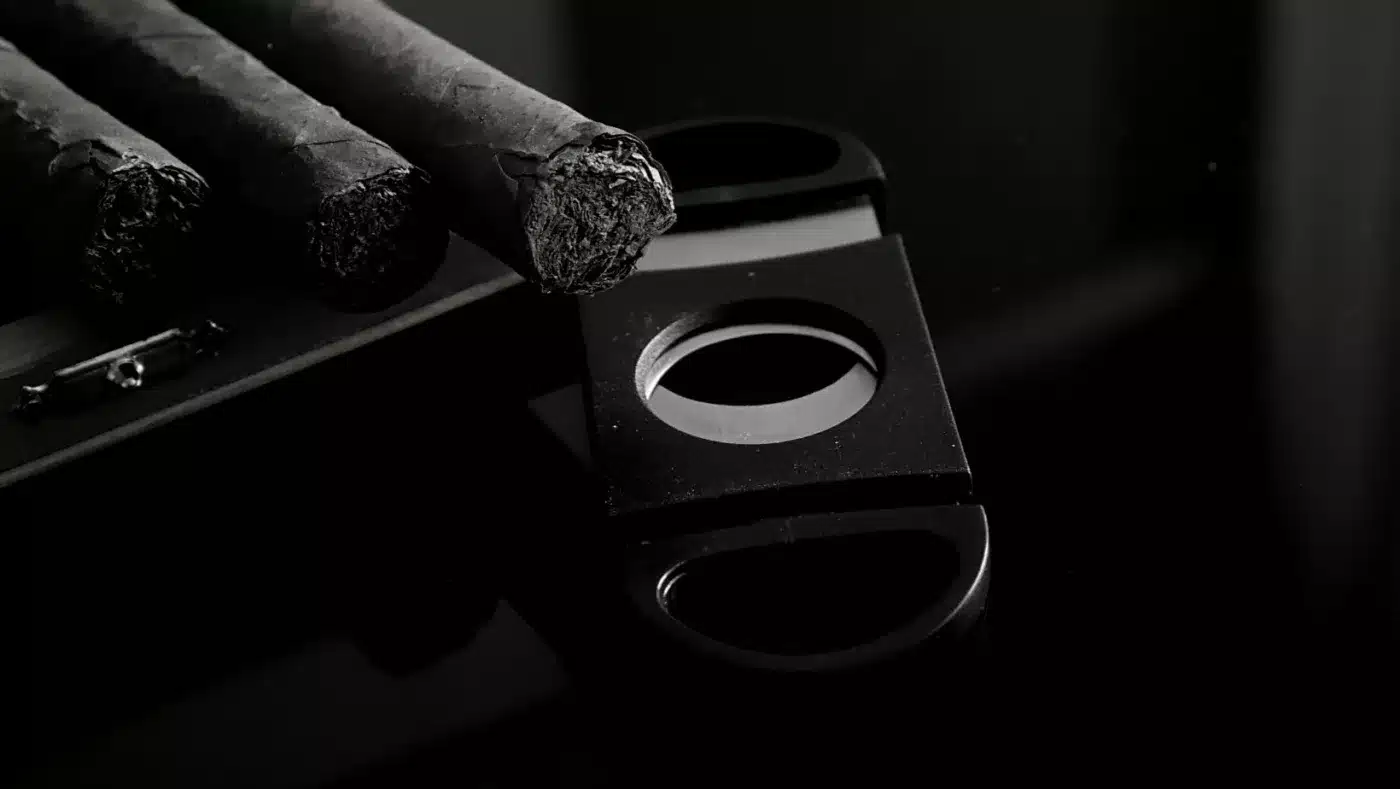 prepping to v-cut a cigar